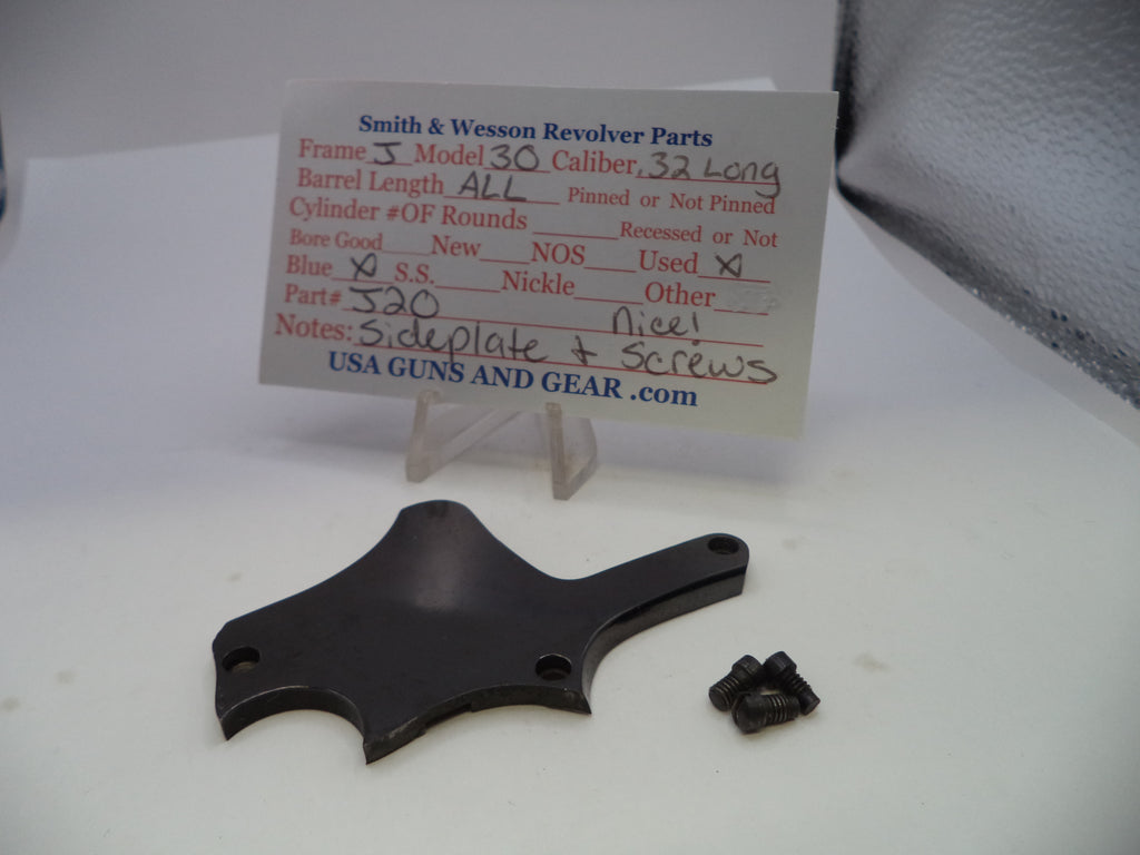 A black metal revolver part and a small black screw displayed on a white surface in front of a handwritten parts card for Smith & Wesson Model 30 revolver parts.