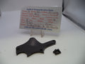 A black metal revolver part and a small black screw displayed on a white surface in front of a handwritten parts card for Smith & Wesson Model 30 revolver parts.
