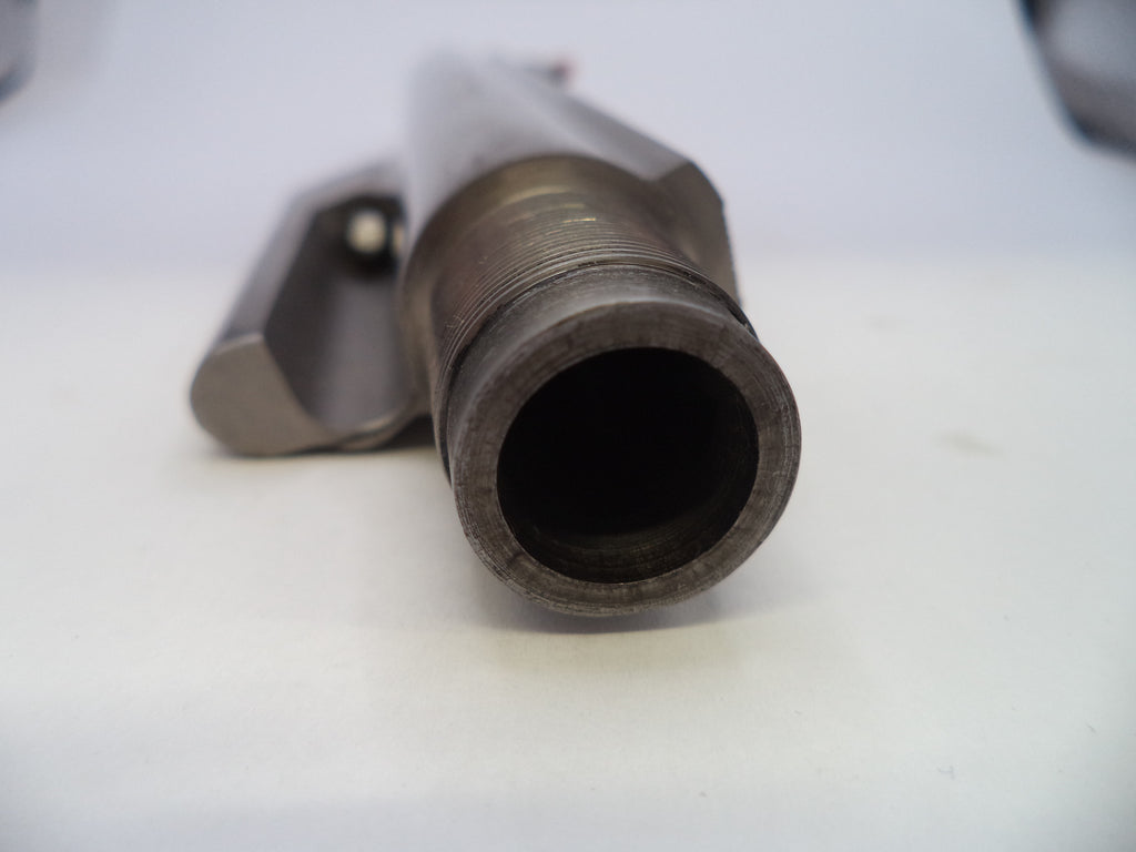 A close-up shot of a metallic cylindrical component with a threaded opening, resting on a plain white surface.