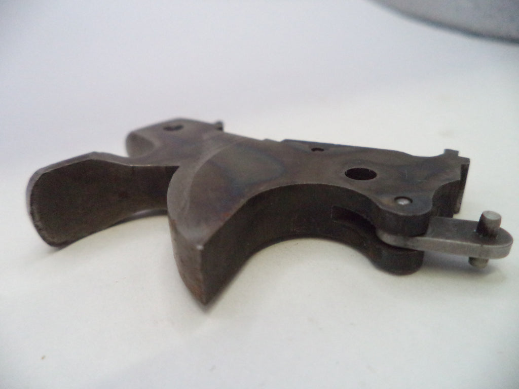 A dark metal firearm trigger assembly, likely a receiver or grip component, photographed on a plain light background.