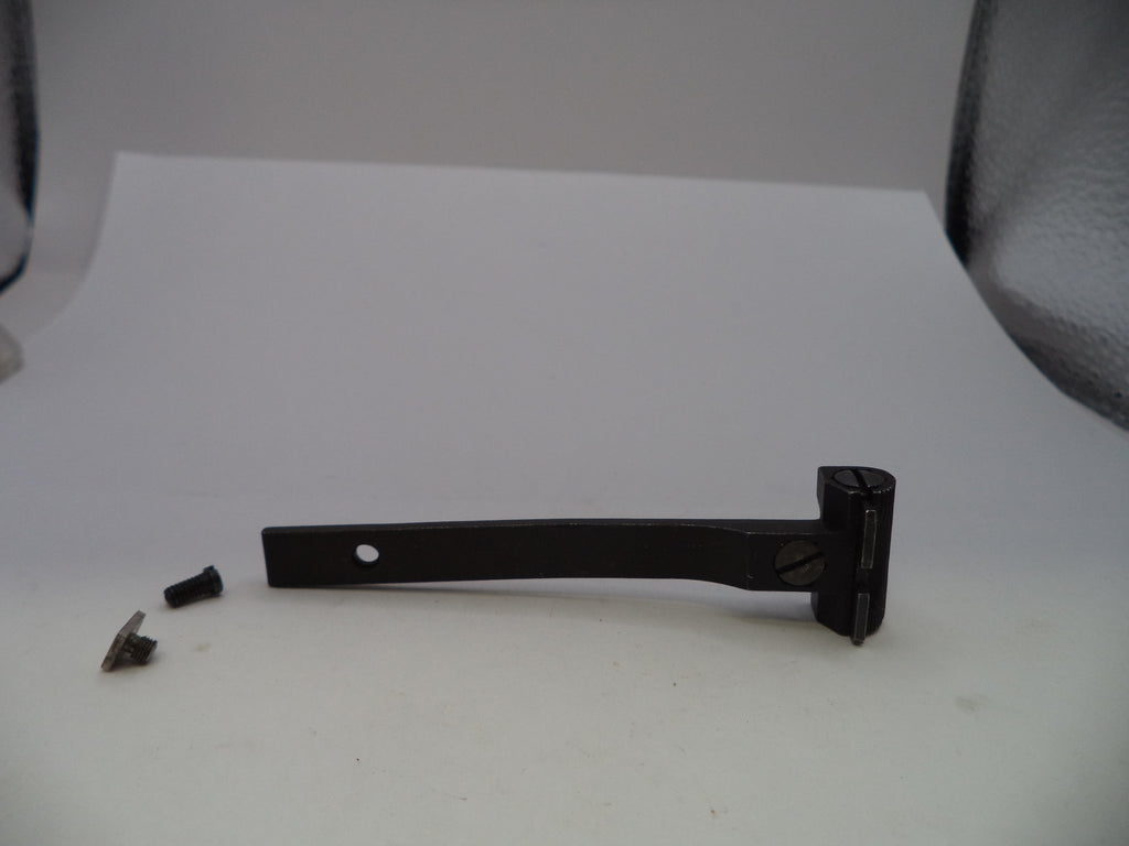 A black metal door lever or handle assembly with a small mounting hole, shown on a white surface with two small screws beside it.