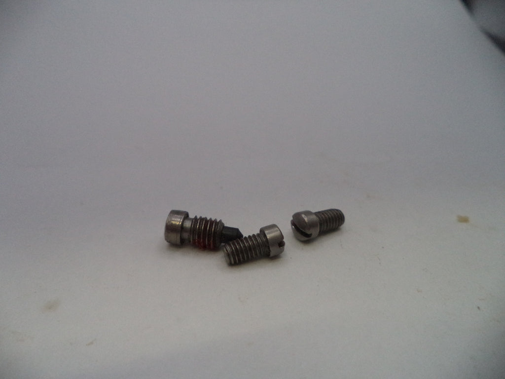 Three small metallic threaded screws or bolts with hex heads, displayed on a plain off-white surface.