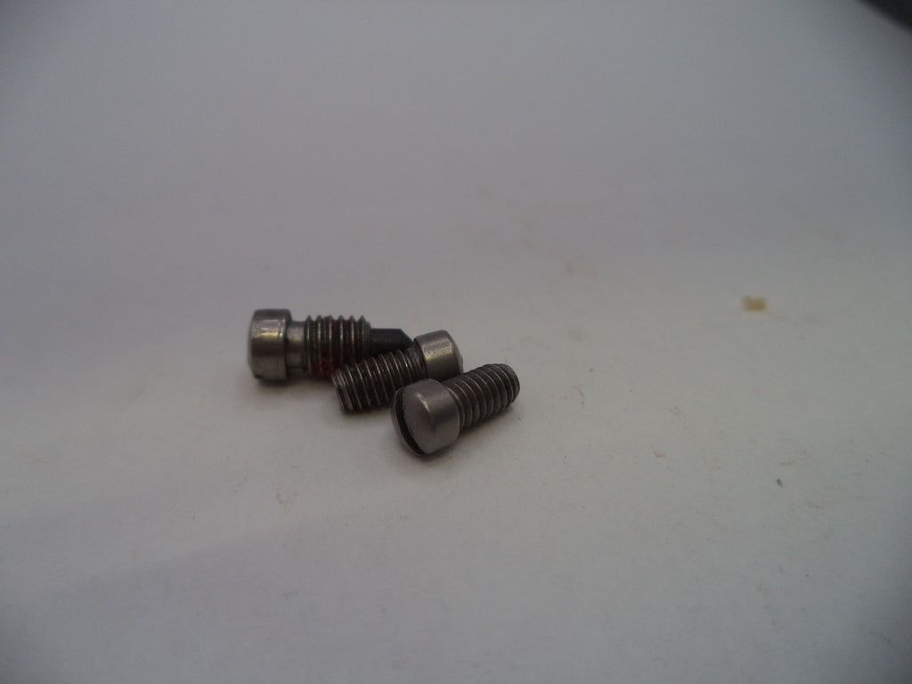 Three small metallic screws with hex heads and threaded shanks, photographed on a plain light background.