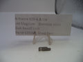 A small used stainless steel bolt recoil lock for a .44 Magnum rifle, displayed on a clear plastic stand next to a paper label card with part details.