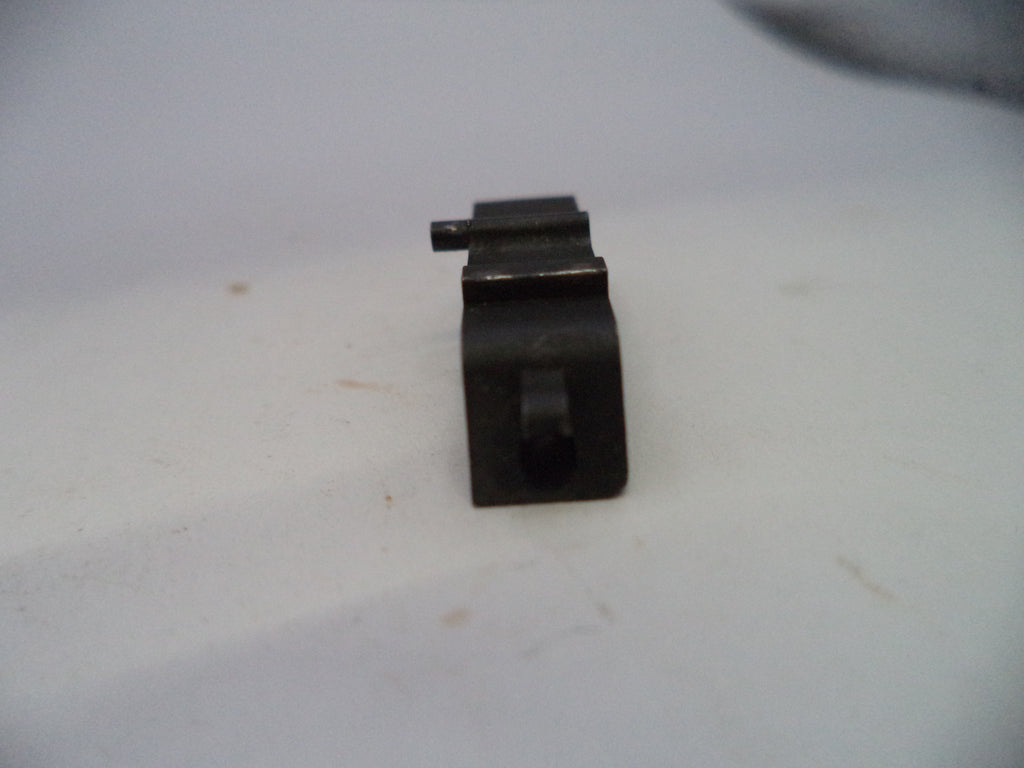 A small black metal hardware component, possibly a bracket or mounting piece, shown on a plain off-white surface.