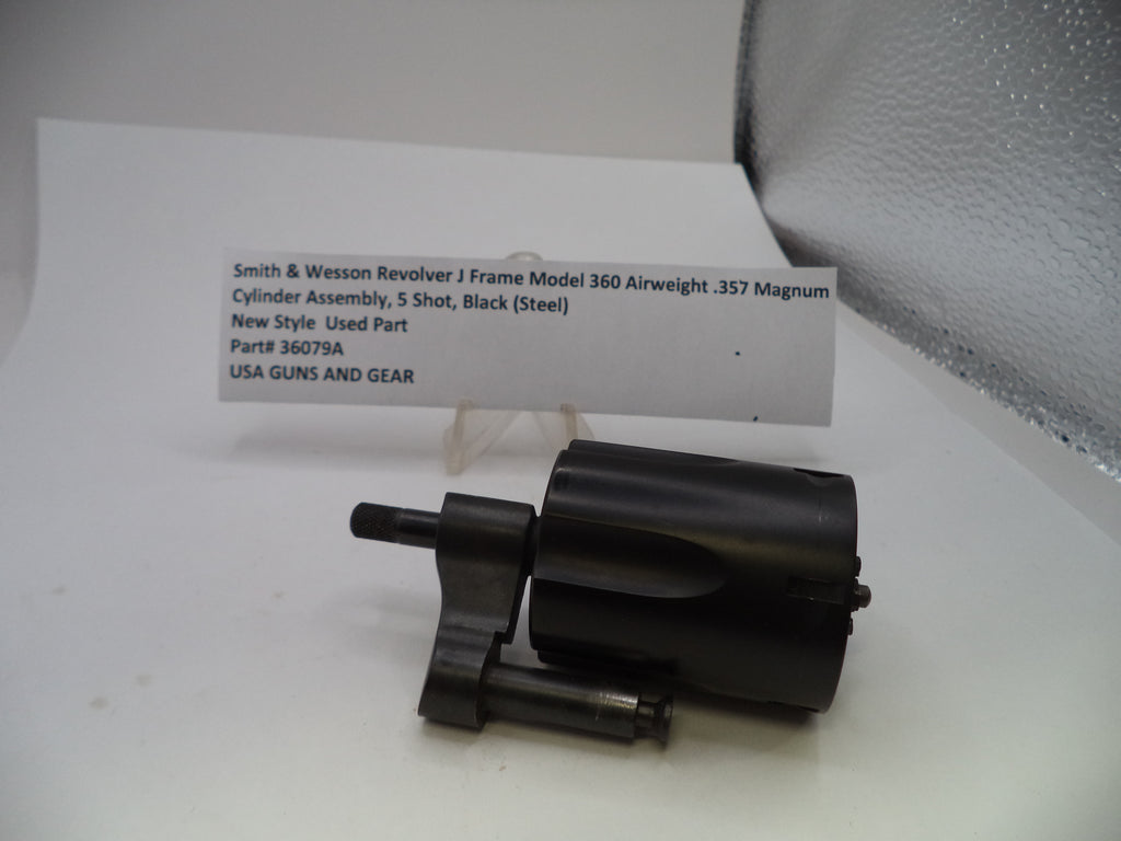 A black metal cylinder assembly part for a Smith & Wesson Revolver J Frame Model 360 airgun, displayed on a white surface with a product information card behind it.