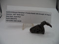 A used Smith & Wesson revolver J frame hammer part displayed on a clear stand in front of a white label card with product details.