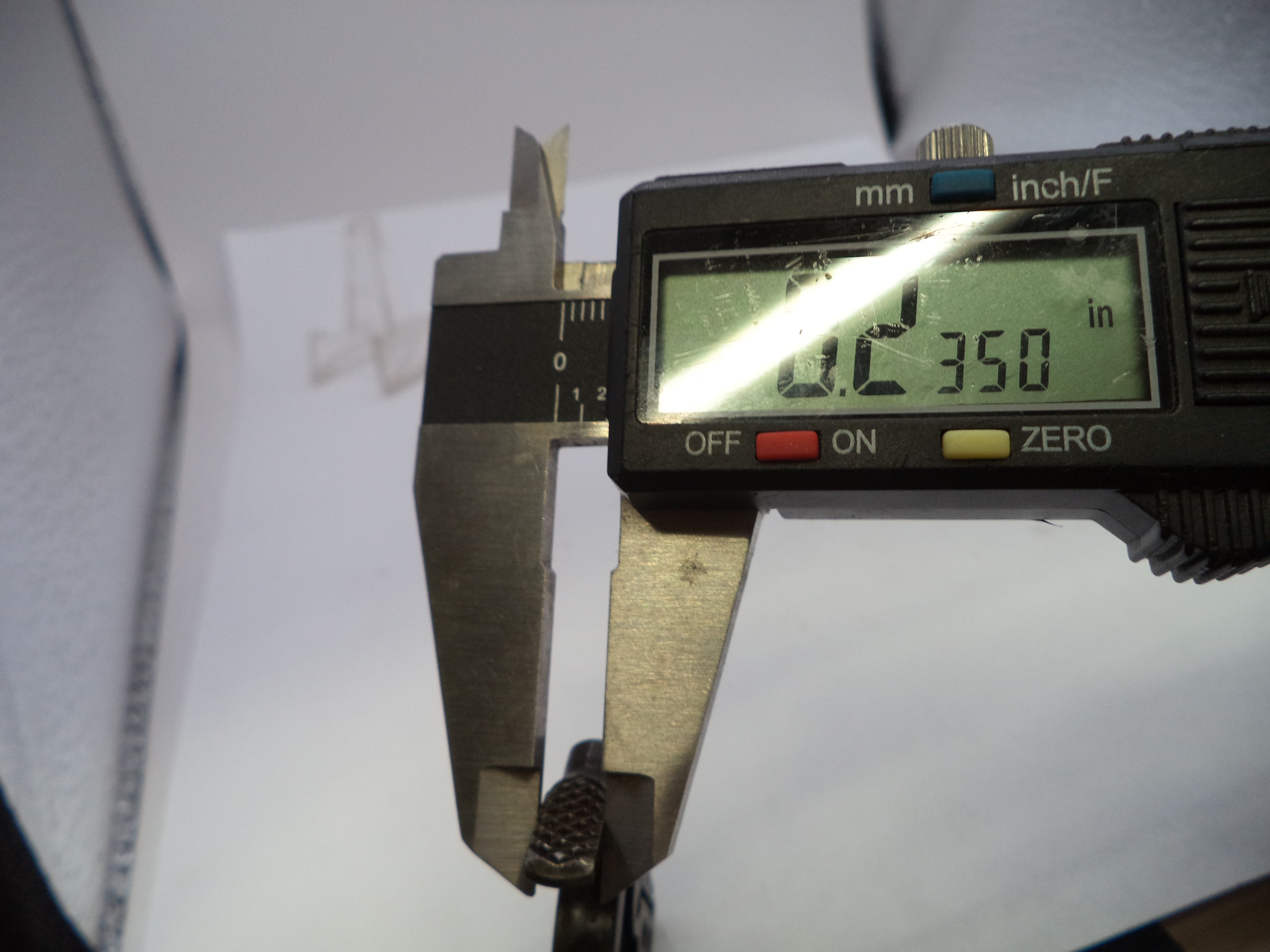A digital caliper measuring device displaying 0.2350 inches (0.02350 m) on a white background.