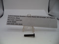 A single black metal grip screw for a Smith & Wesson Revolver J Frame Model 360 Airweight .357 Magnum, shown on a white surface with a paper label card in the background.