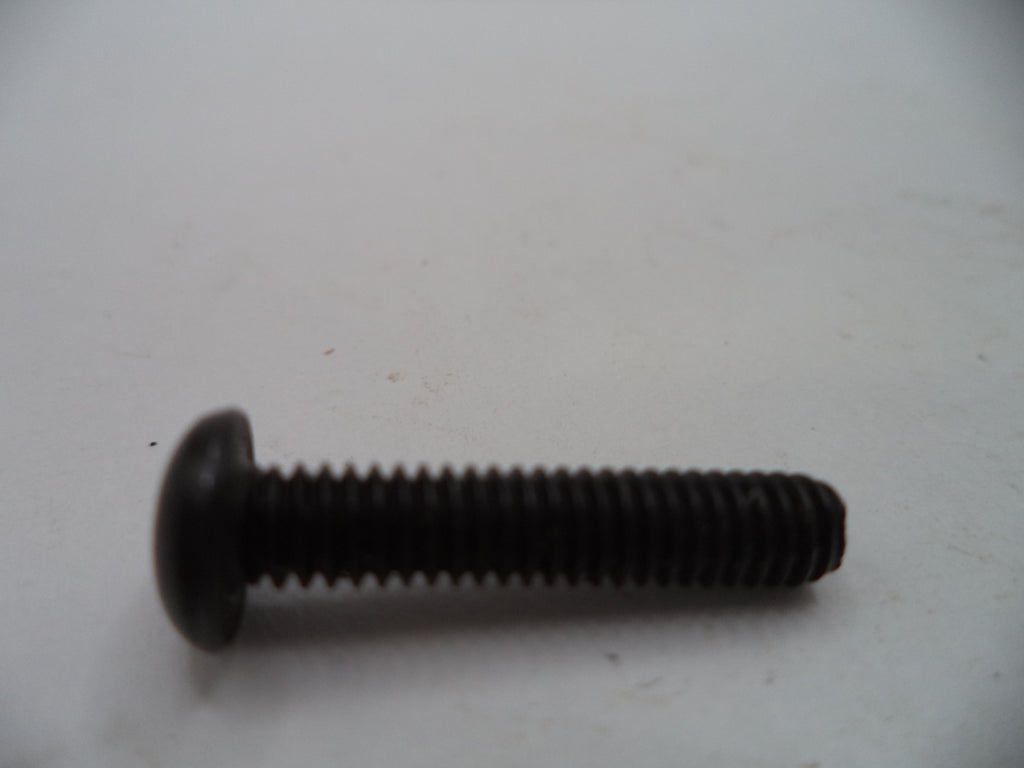 A single black metal flathead screw with a threaded shank, photographed on a plain off-white surface.