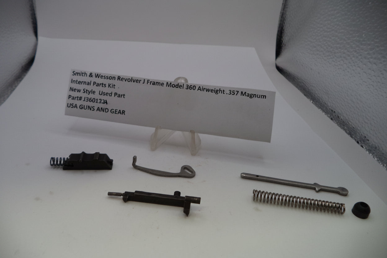 Smith & Wesson Revolver J Frame Model 360 Airweight .357 Magnum internal parts kit components laid out on a white surface with a paper label card in the center.