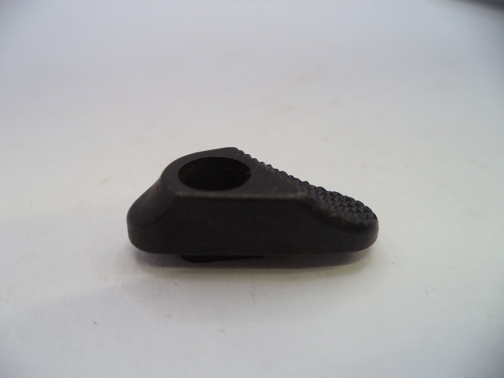 A small black plastic or rubber component with a circular opening and textured ridges on one side, photographed on a plain light background.
