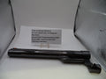 A black Smith & Wesson revolver receiver or barrel component displayed on a white surface with a printed parts information card behind it, set against a silver reflective backdrop.
