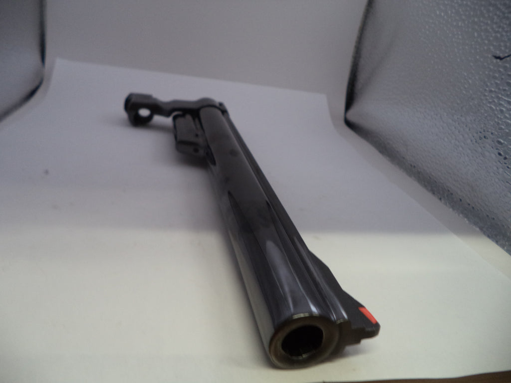 A black metal shotgun barrel with a matching black receiver and foregrip, photographed on a white studio sweep with a textured gray backdrop visible on the right.