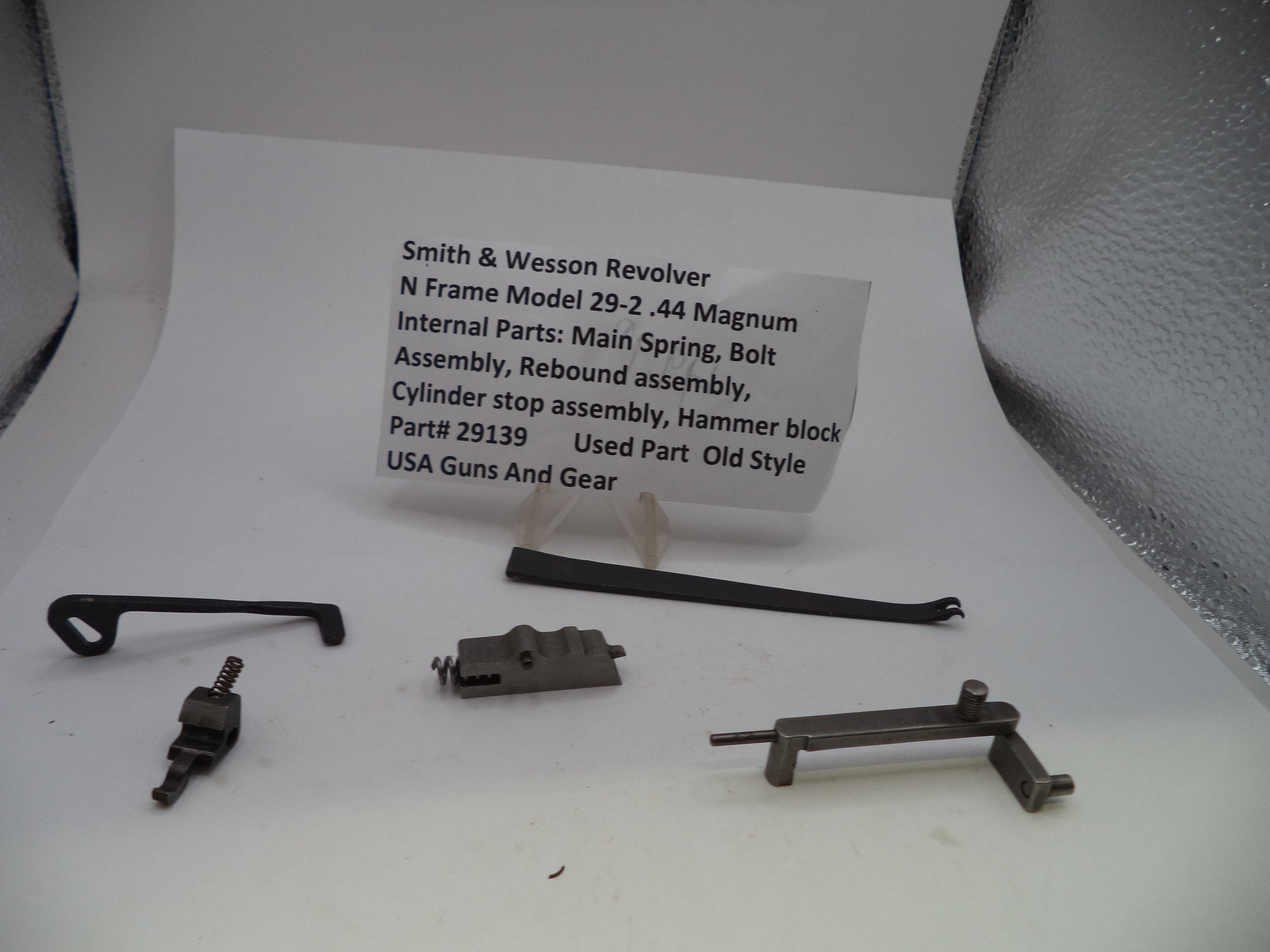 Smith & Wessex Revolver N Frame Model 29-2 .44 Magnum internal parts laid out on a white surface with a printed parts list card behind them, including main spring, bolt, assembly, rebound assembly, cylinder stop assembly, hammer block, and part number 29139.