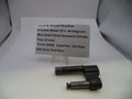A used Smith & Wesson revolver cylinder yoke part, made of blue steel, displayed on a small clear stand next to a paper label card with product details.