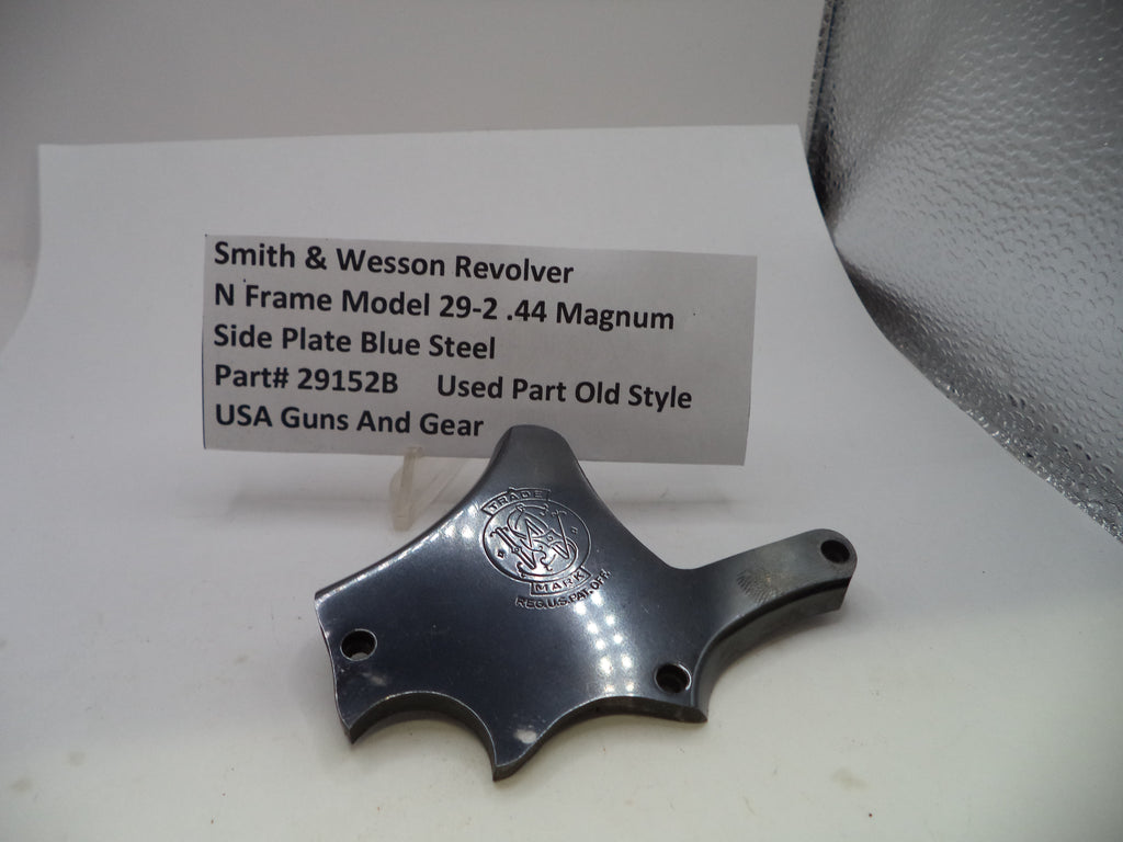 A used metallic gun part for a Smith & Wesson revolver, displayed on a white surface with a product information card behind it.