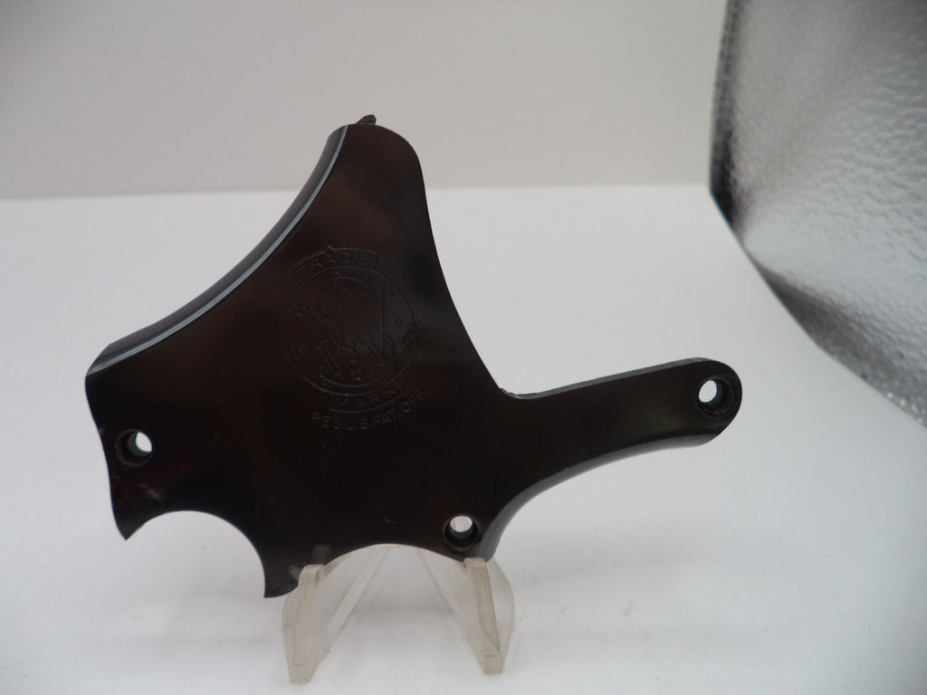 A dark brown glossy hard case or cover with a curved shape, displayed on a clear stand against a white background.