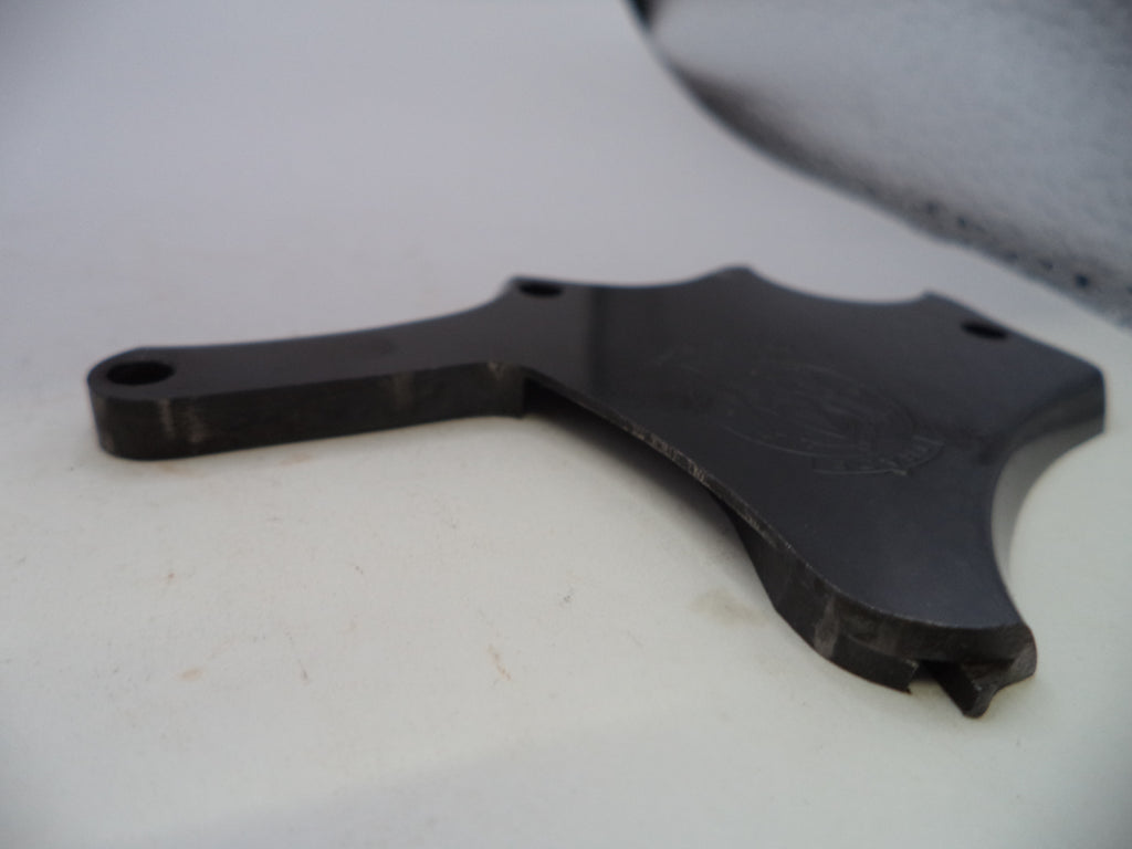 A black metal mounting bracket or hardware piece with pre-drilled holes, photographed on a white surface.