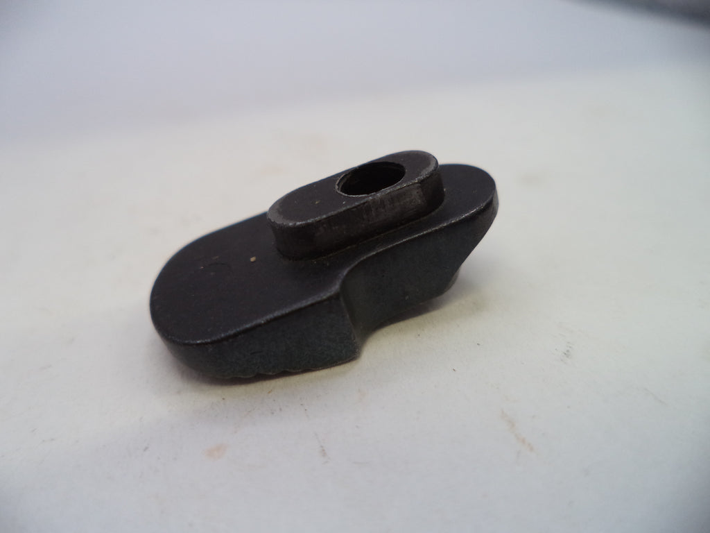 A small black metal mechanical component or hardware piece with a flat base and a raised oval section, photographed on a plain off-white surface.