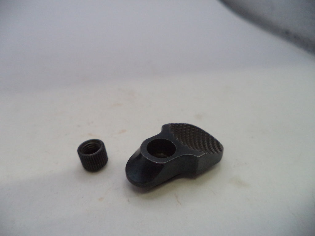 A small black metal hardware component with a textured grip surface and a separate matching threaded cap, photographed on a plain off-white surface.