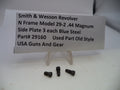 Three small dark metal screws displayed in front of a white sign that reads 'Smith & Wesson Revolver N Frame Model 29-2 .44 Magnum Side Plate 3 each Blue Steel Part# 29160 Used Part Old Style USA Guns And Gear' on a white surface.