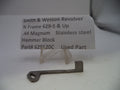 A small metal used part for a Smith & Wesson revolver, displayed on a clear plastic stand in front of a white label card with product details.