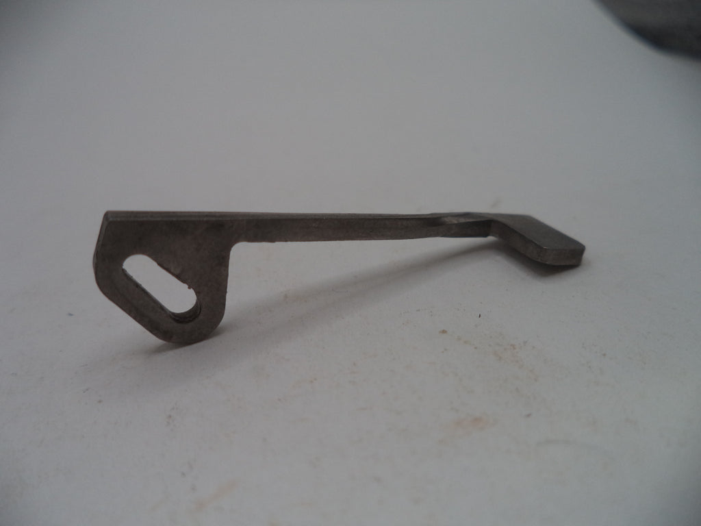A small dark metal tool or hardware piece with a looped end and flat angled end, photographed on a plain light surface.