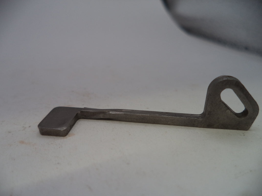 A small metal key-shaped tool with a loop at one end, photographed on a plain light background.