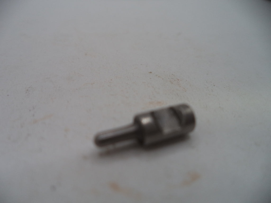 A small metallic cylindrical pin or connector with a threaded body and a short shank, shown on a plain off-white surface.