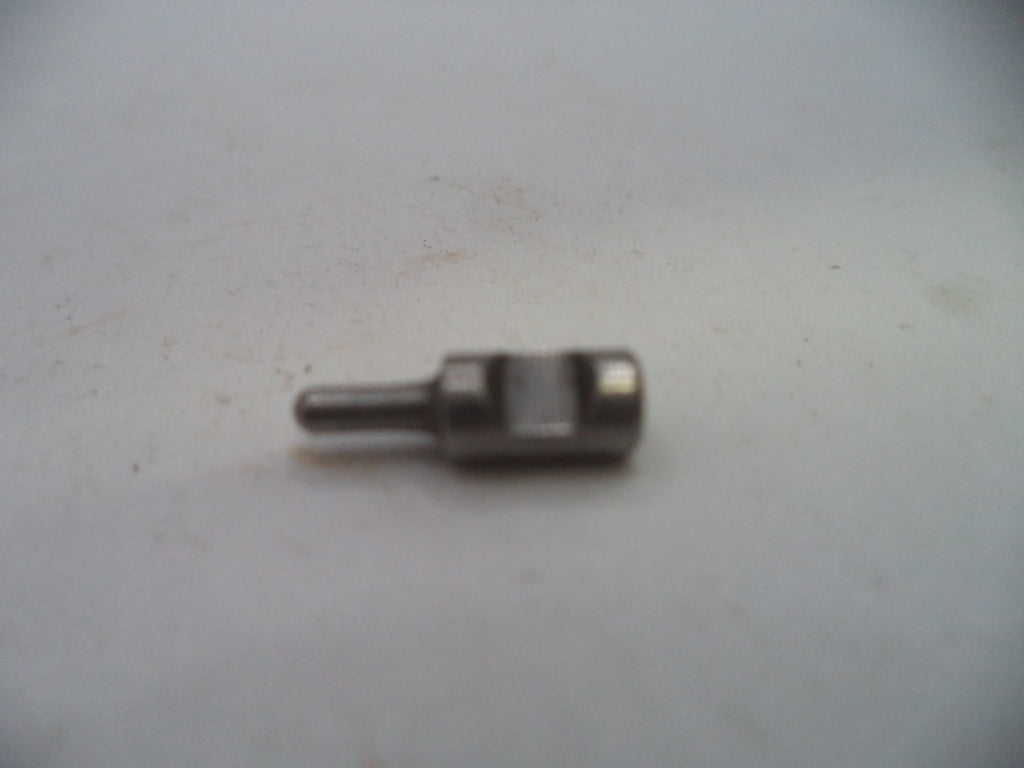 A small metallic mechanical pin or connector with a cylindrical shaft and a square-shaped head, resting on a light gray surface.