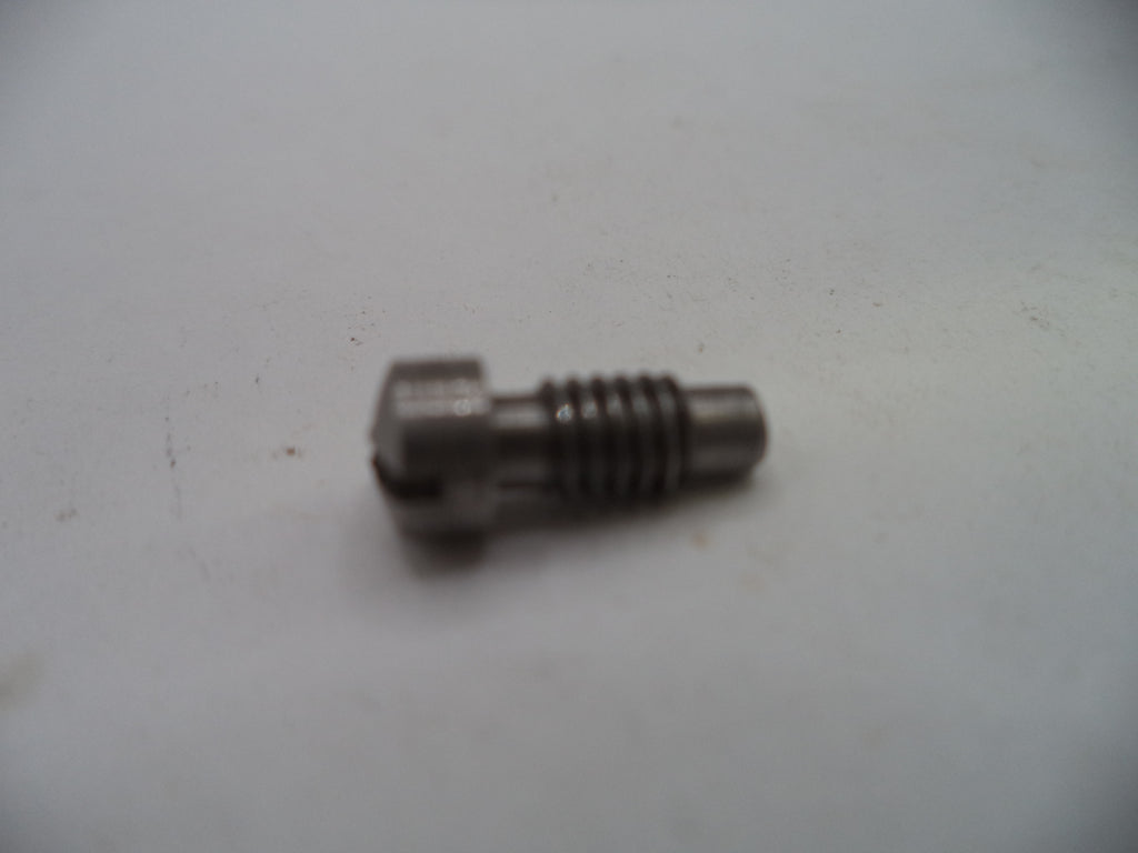 A small metallic threaded pin or bolt component on a plain off-white surface.