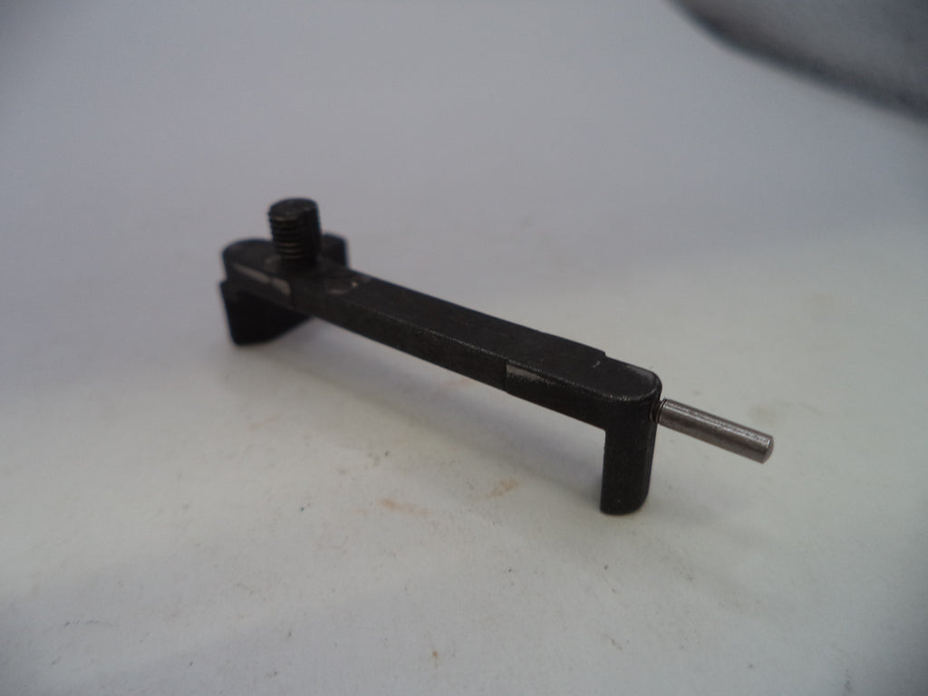 A small black metal tool or hardware piece with a threaded screw and a silver pin, photographed on a plain light background.
