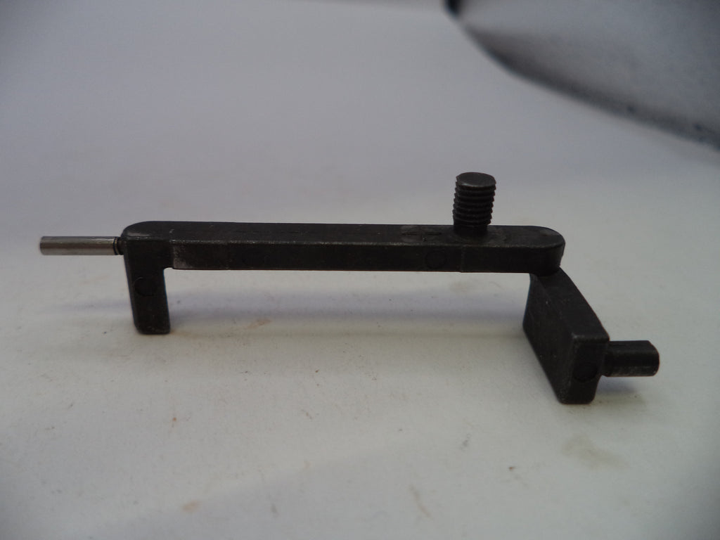 A black metal mechanical tool or fixture with a threaded screw post and a short protruding pin, photographed on a plain light background.