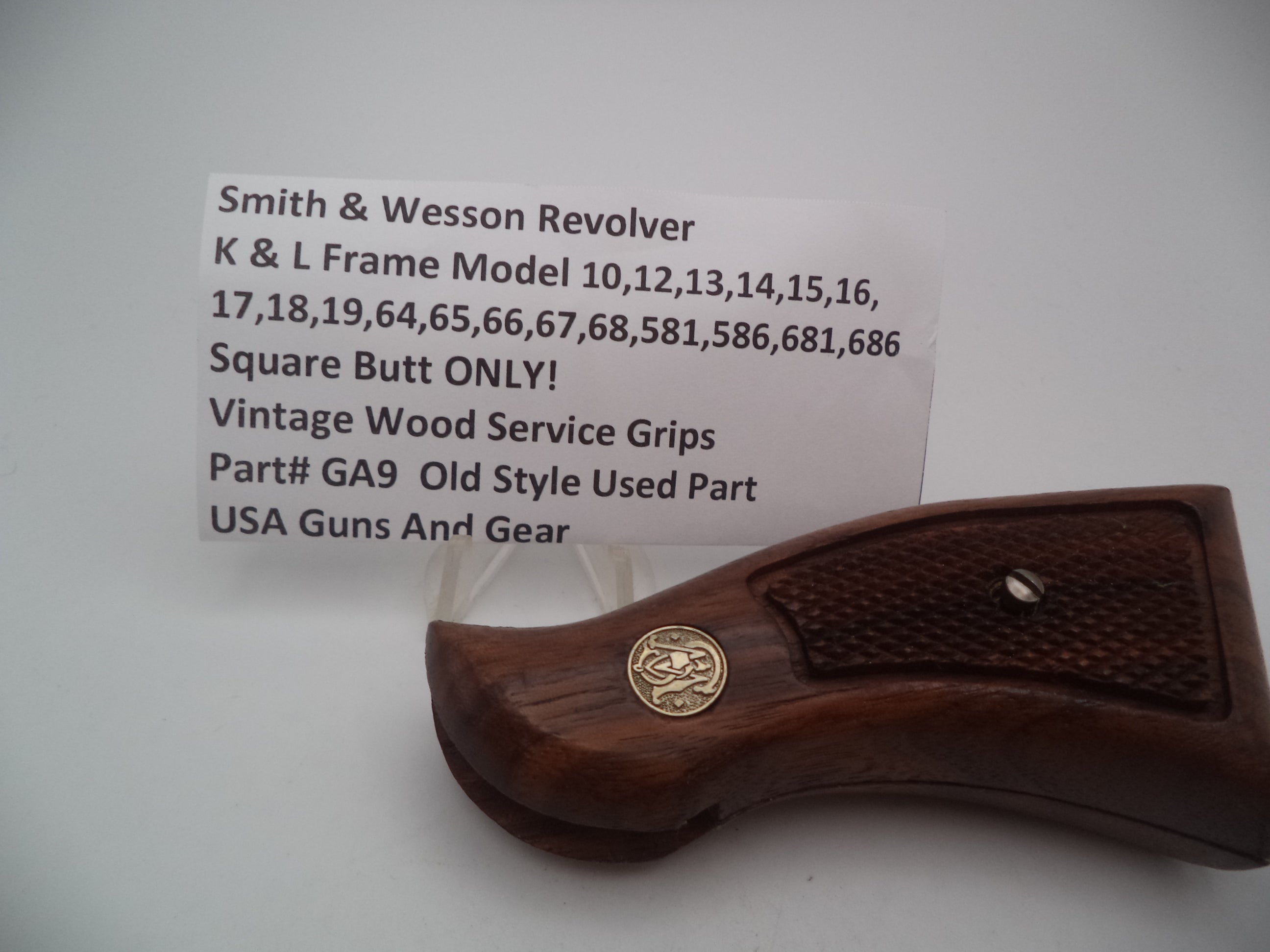 A vintage wood service grip for an S&W L Frame multi model pistol, displaying the model number 10 on the tag.