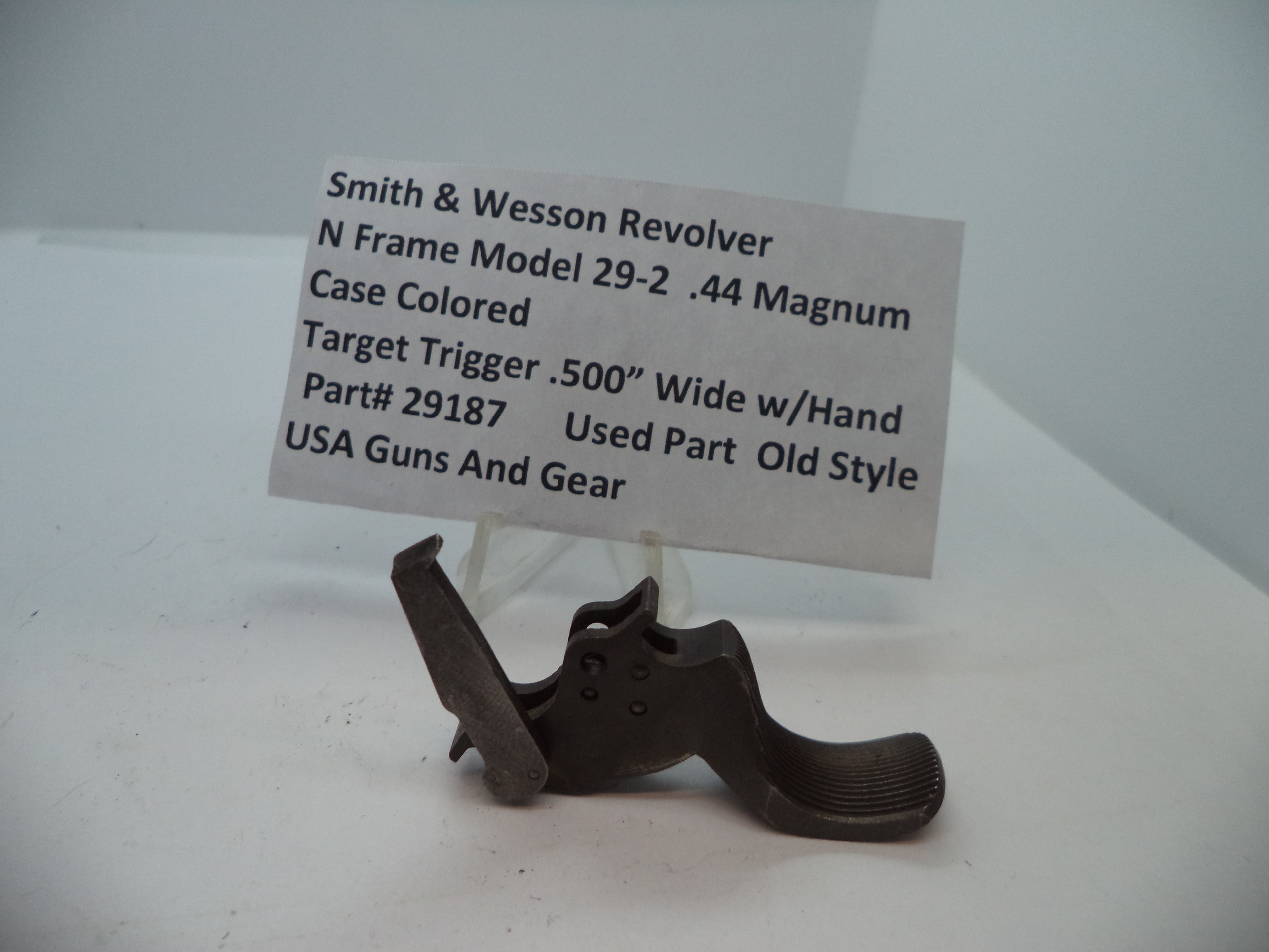 Smith & Wesson N Frame Model 29-2 .44 Magnum case colored target trigger with hand ejector, displayed on a white stand with a label providing product details.
