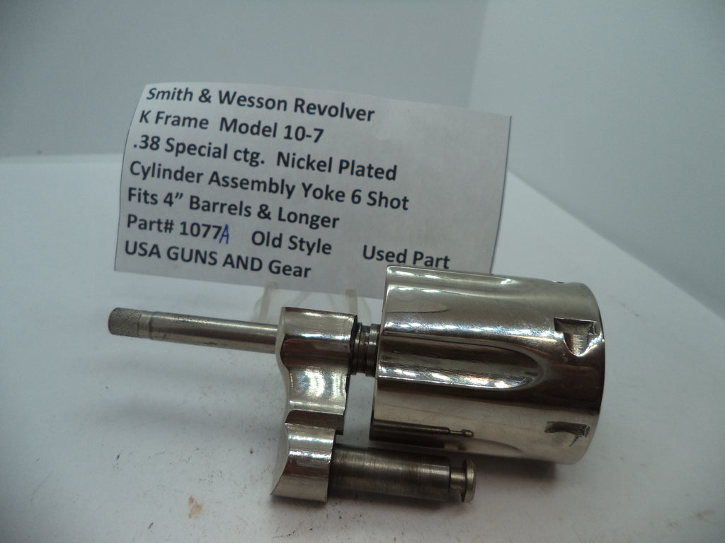Smith & Wesson revolver cylinder assembly yoke, nickel plated, for .38 special cartridge, with part number 1077A.