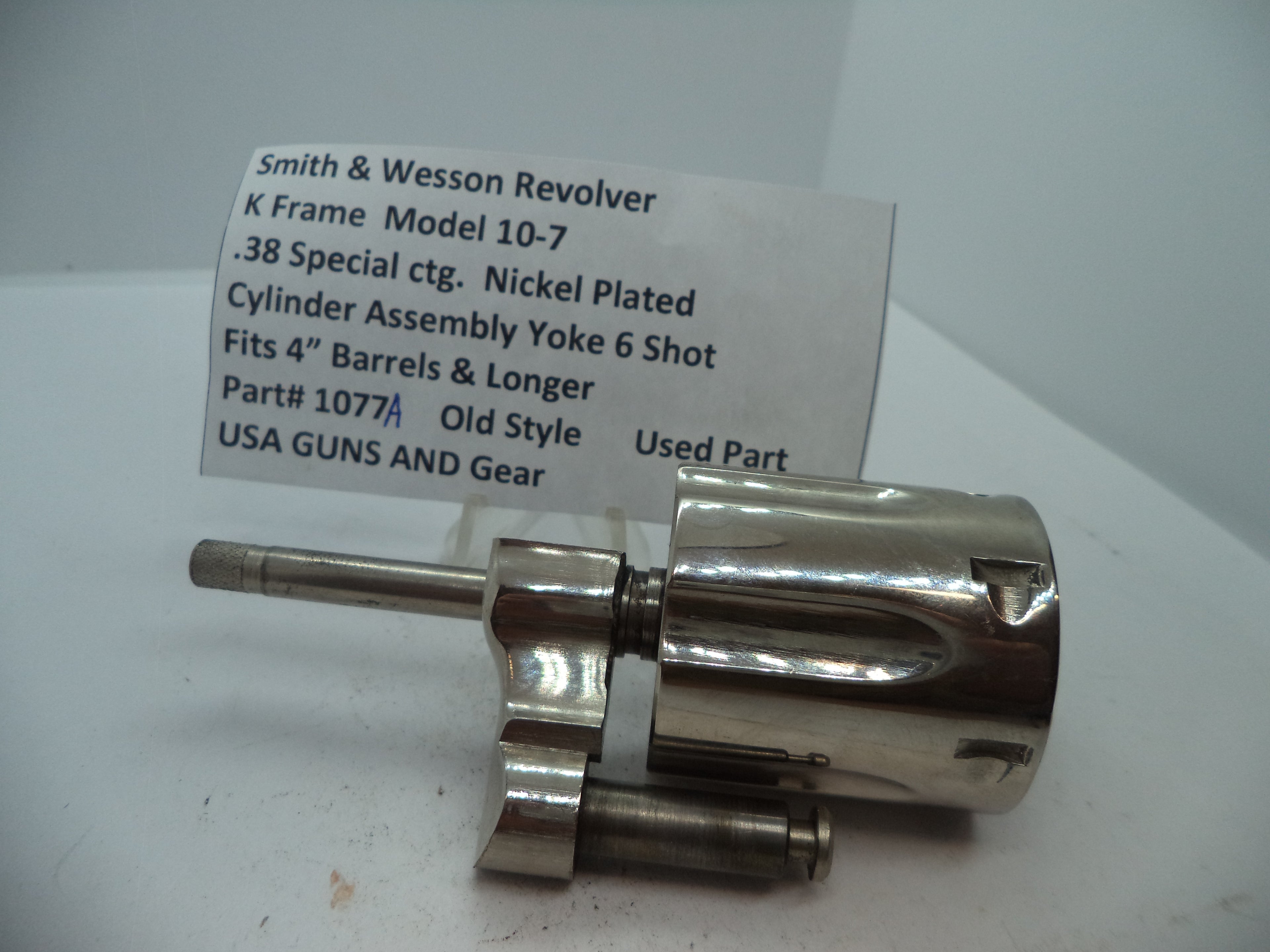 Smith & Wesson revolver cylinder assembly yoke, nickel plated, for .38 special cartridge, with part number 1077A.
