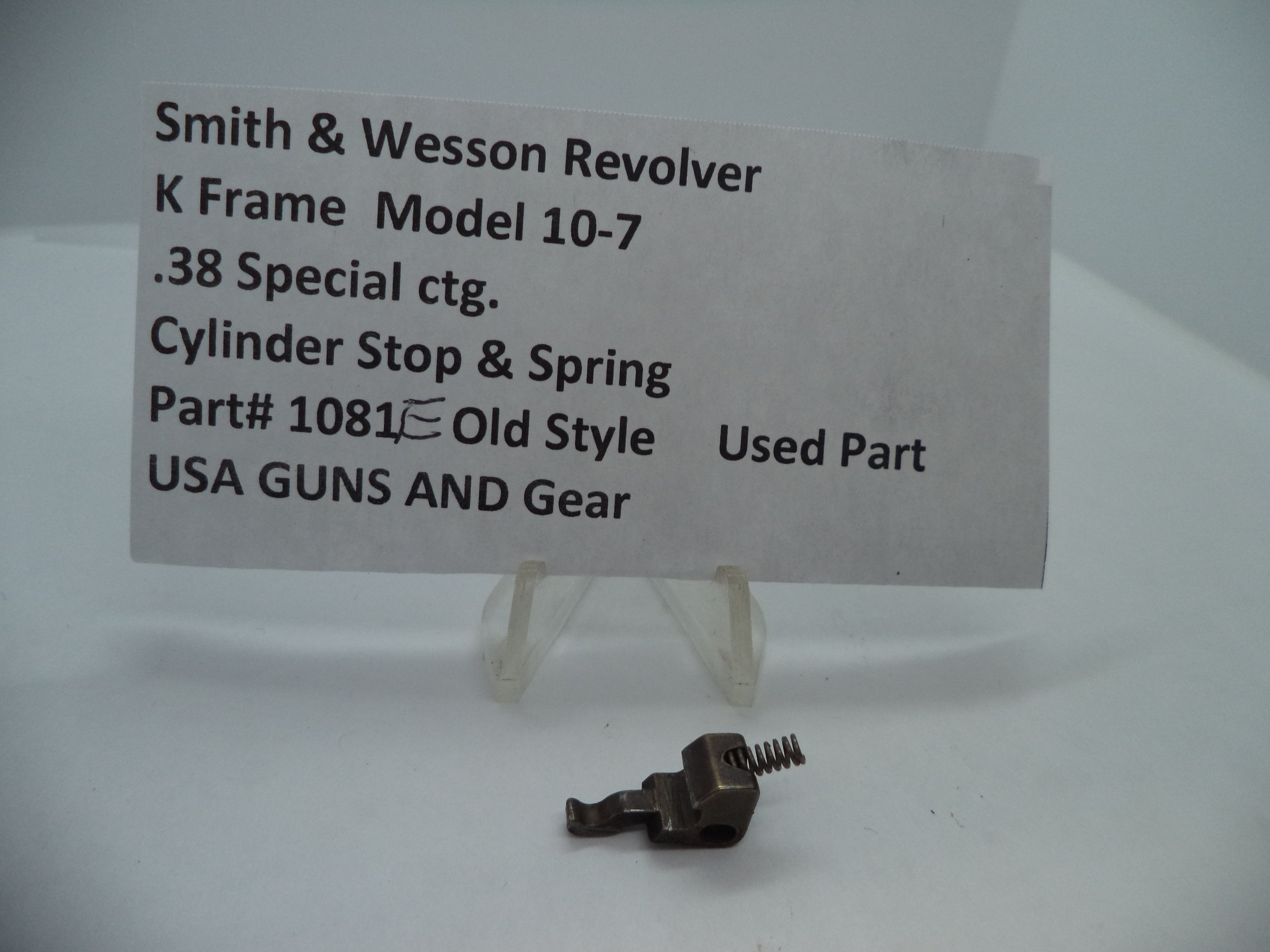 A metal cylinder stop and spring part labeled as Smith & Wesson K Frame Model 10-7, .38 Special ctg.