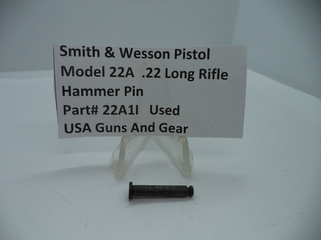A .22 long rifle hammer pin for a Smith & Wesson Model 22A pistol, displayed on a white card with the product details, indicating it is a used part.