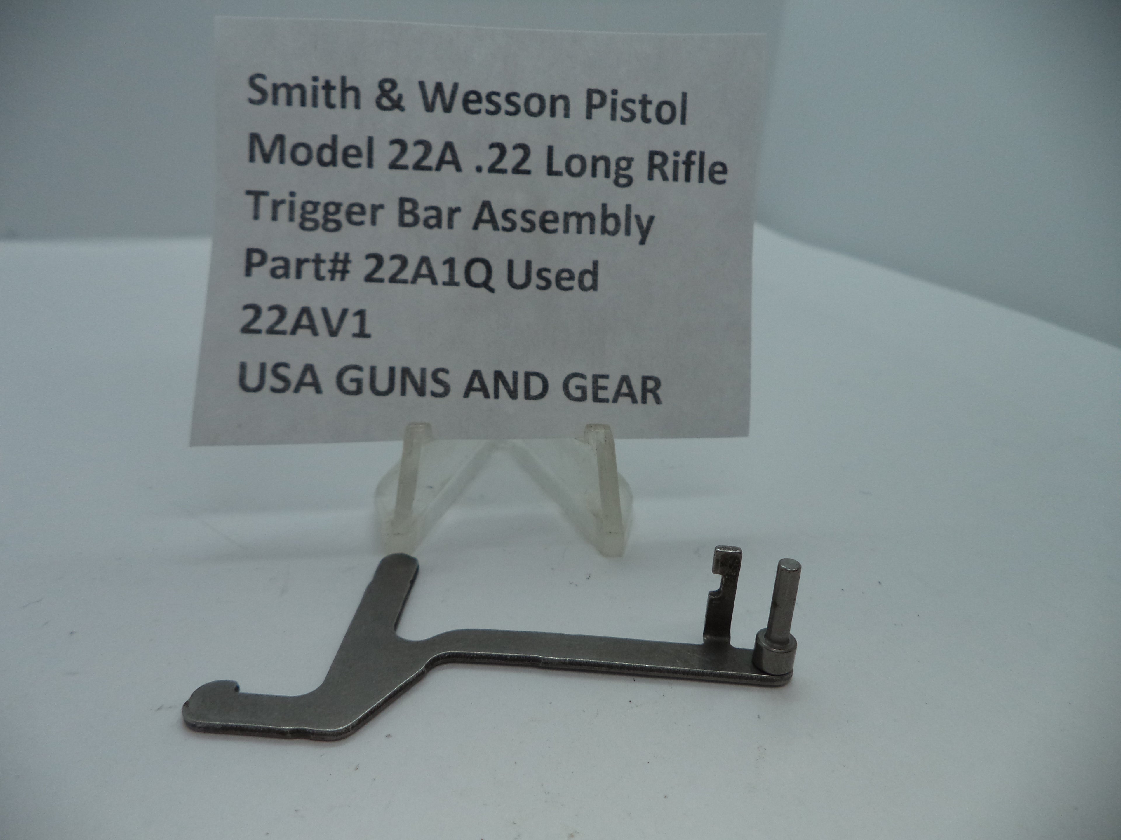 Smith & Wesson Pistol Model 22A Trigger Bar Assembly for .22 Long Rifle displayed on a white surface with a label providing product details.