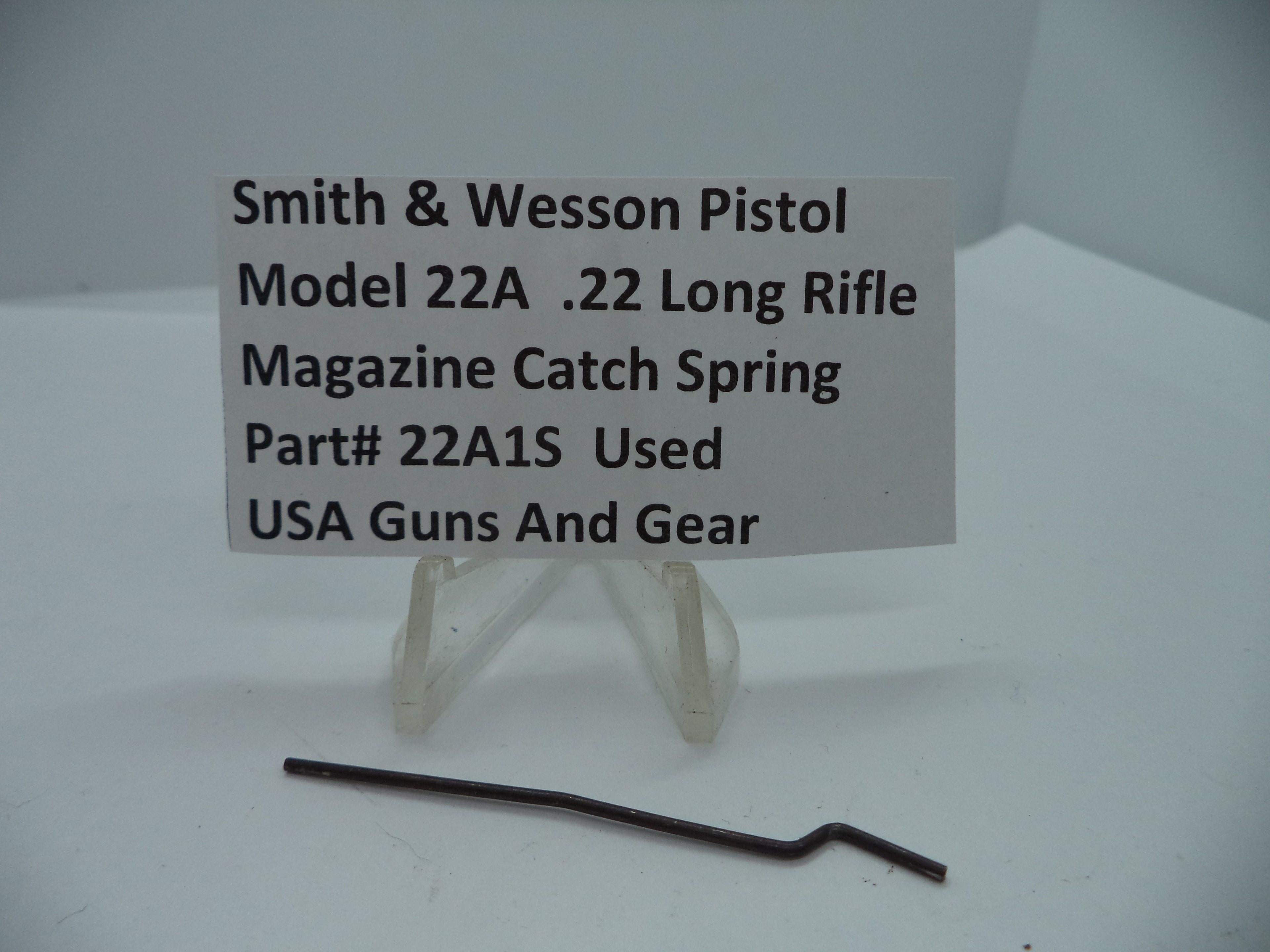 Smith & Wesson Pistol Model 22A Magazine Catch Spring for .22 Long Rifle displayed on a white card.