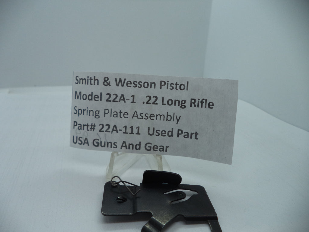 Smith & Wesson Model 22A-1 .22 Long Rifle Spring Plate Assembly, displayed on a white background with a descriptive label in front.