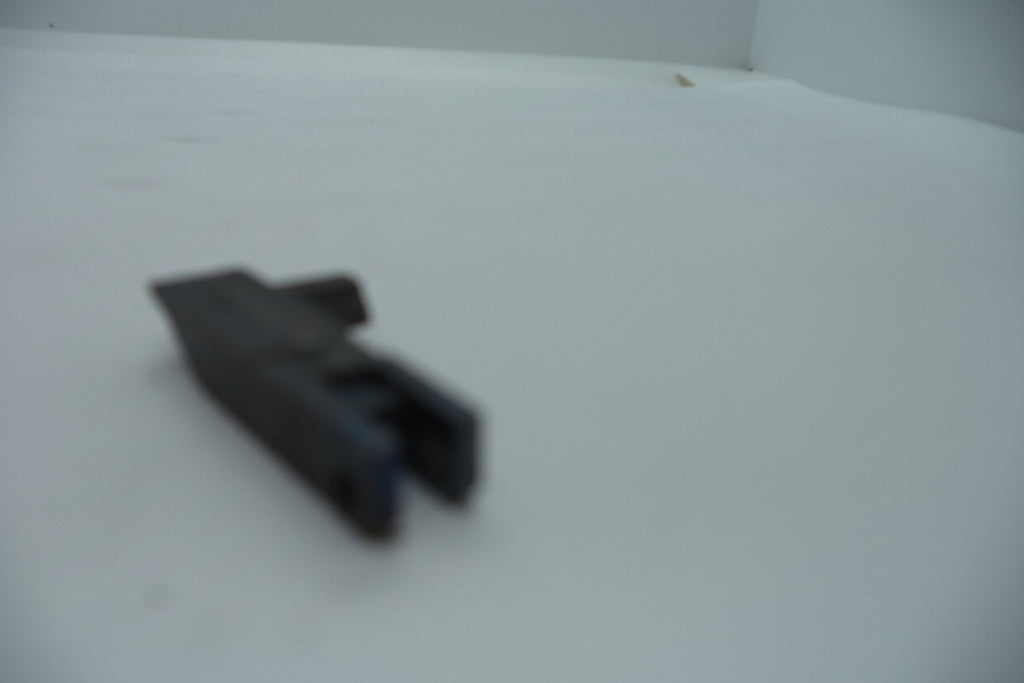 Smith & Wesson pistol sear part for Model 22A-1 in .22 Long Rifle, displayed on a white surface.
