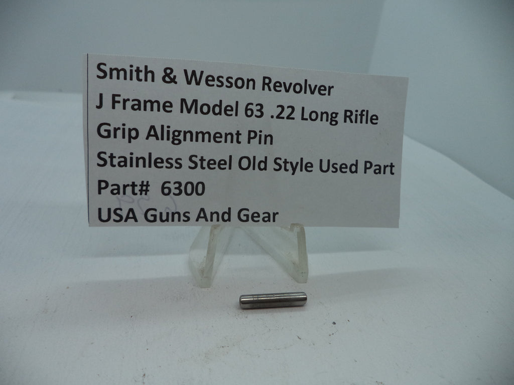 A stainless steel grip alignment pin for a Smith & Wesson J Frame Model 63 revolver, displayed on a white stand with a label providing product information.
