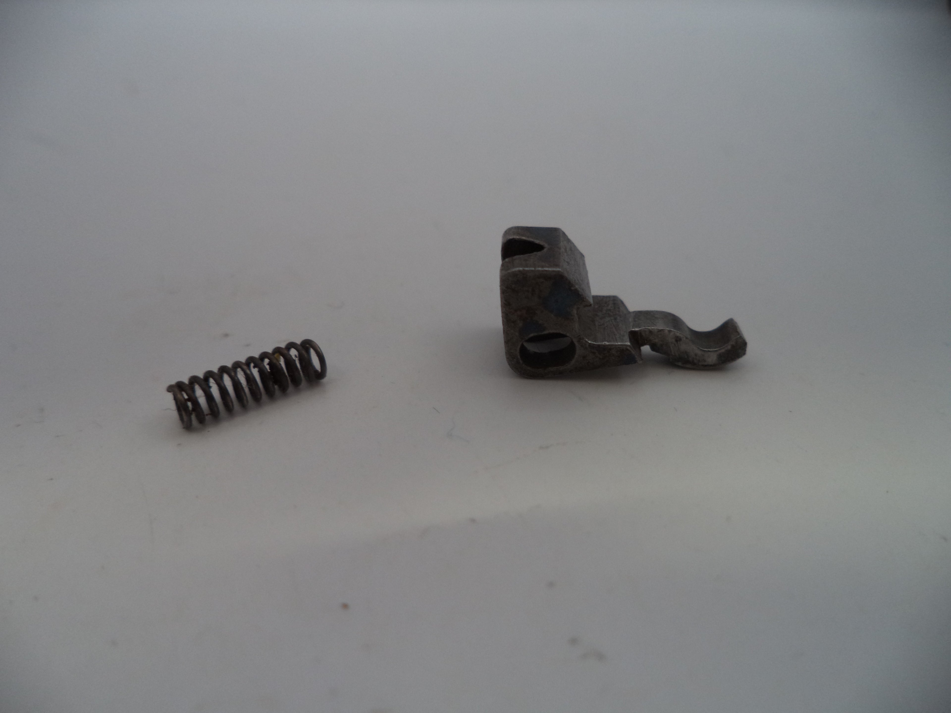 Metal spring and metal bracket on a white background