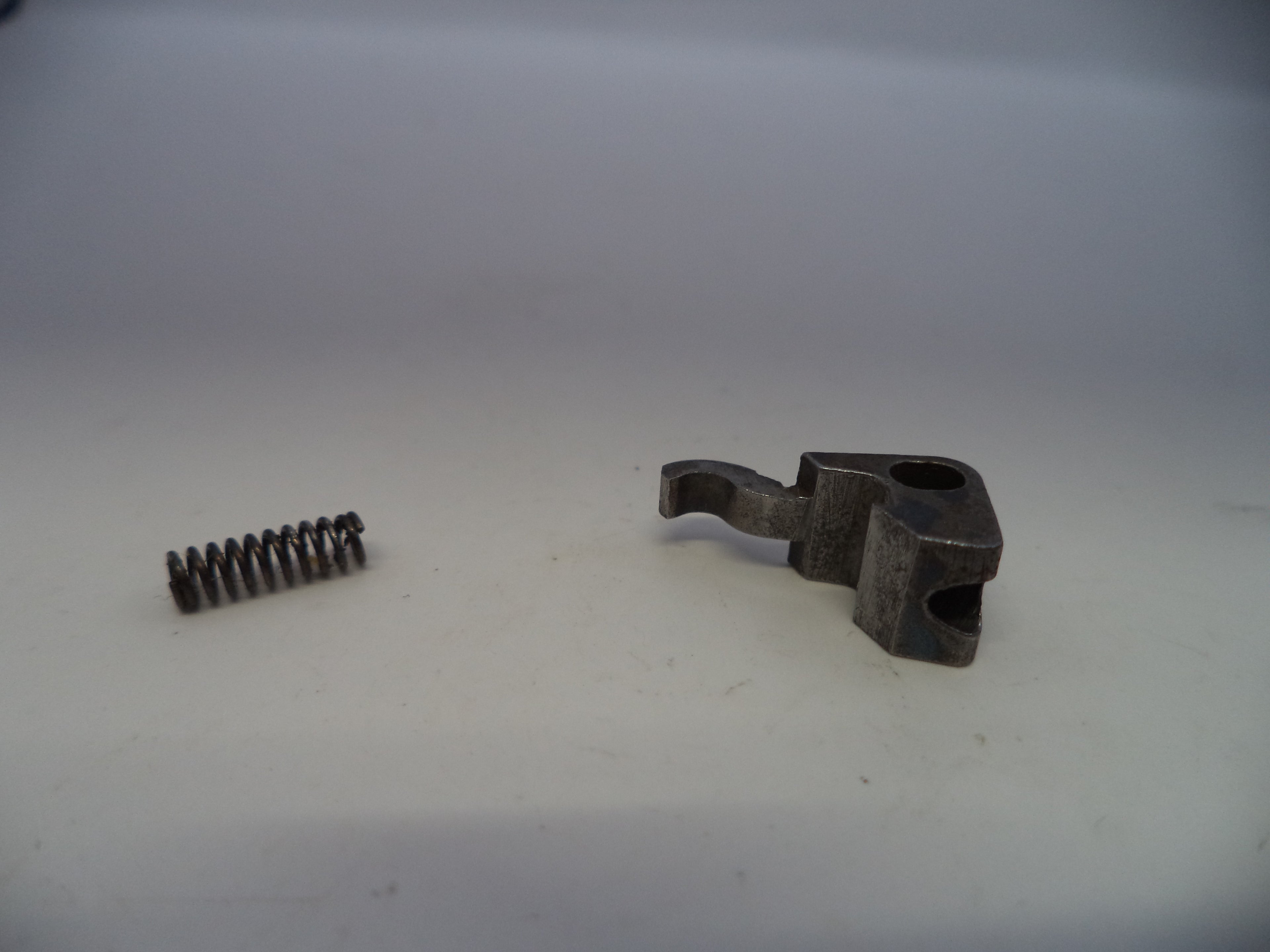 Metal spring and metal bracket on a white background