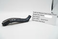 Black gun part with a label for Smith & Wesson semi-auto pistol on a white background