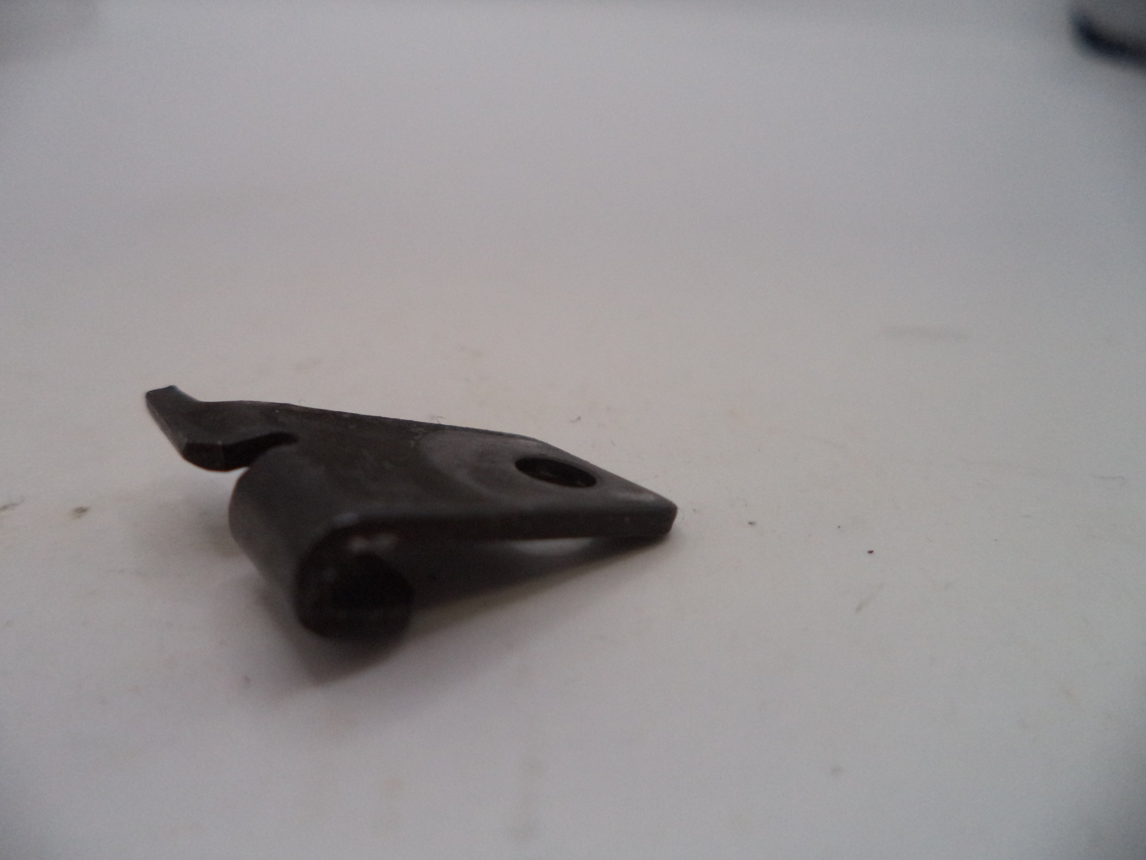 Black metal bracket on a white surface