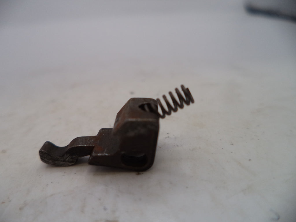 Rust-colored metal component with a spring on a light background